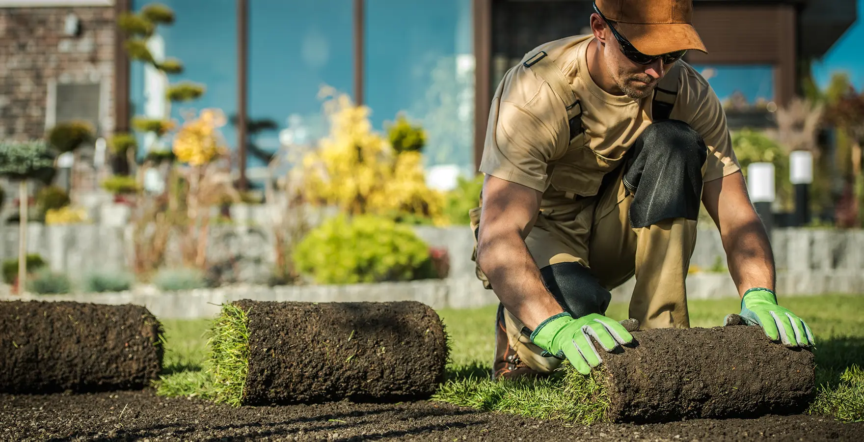 Worker unrolling turf