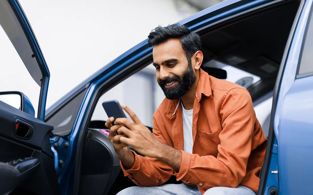 Man sitting in open car