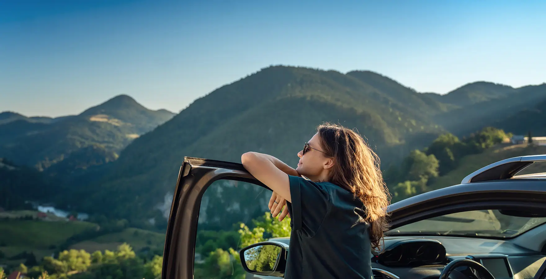 Woman leaning on car door